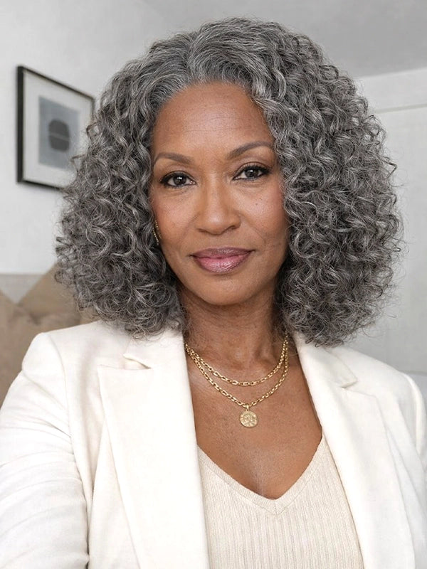 Front view of a medium-length salt and pepper gray wig with loose water wave curls, worn by a real model, made of 100% human hair, ideal for natural, elegant everyday look