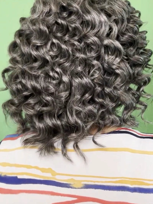 African American woman in Luvwin Salt & Pepper Wand Curl Kinky Hair Bob Wig, voluminous soft curls, realistic gray highlights, 5x5 pre-cut lace, 100% human hair, beginner-friendly wig suitable for evening outings, brunches, office, or casual social occasions
