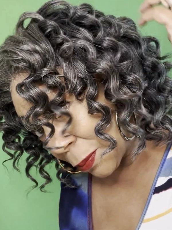 Mature African American woman wearing Luvwin Wand Curl Kinky Hair 5x5 Pre-cut Lace Bob Wig, soft defined curls, realistic gray highlights, beginner-friendly human hair wig, stylish and easy-to-wear for parties, work events, and weekend activities