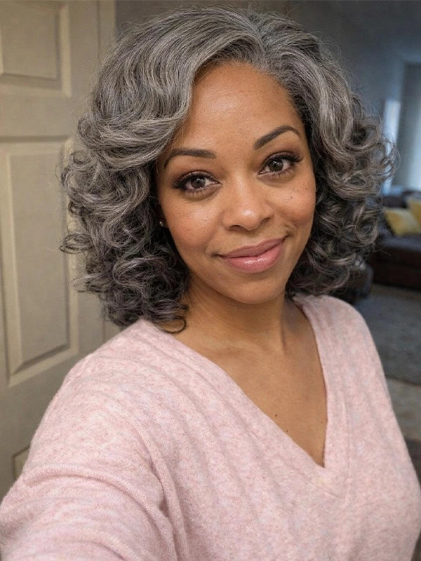 Natural looking salt and pepper grey bob wig on a woman with soft retro waves and realistic steel grey color.