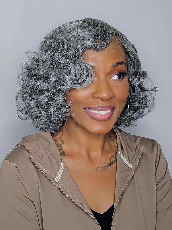 Salt and pepper grey curly bob wig on a woman with steel grey retro waves and a natural realistic look.