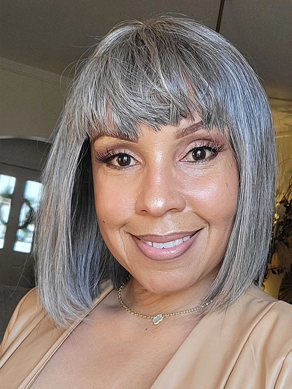 A woman wearing the Salt and Pepper full machine-made bang wig with small lace, perfect for women aged 30–60. Suitable for daily wear, office, or casual outings, giving a natural and confident style.
