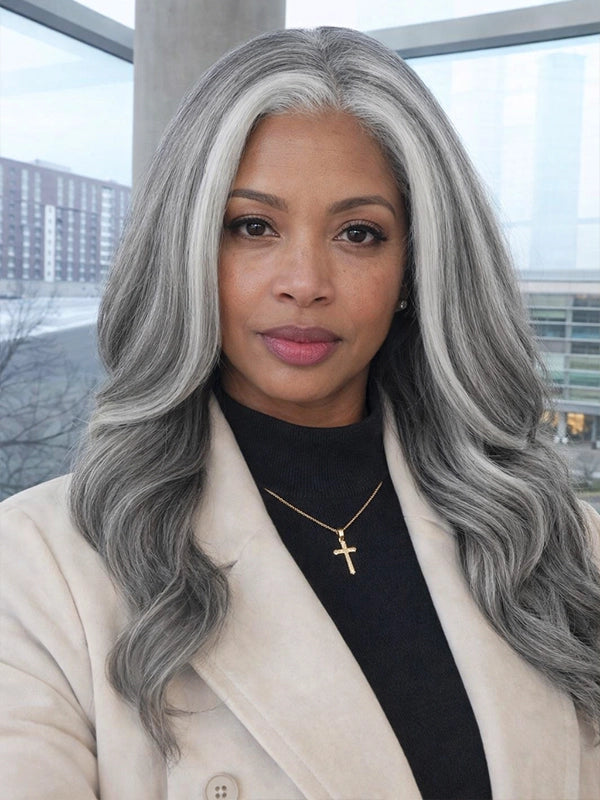 Front view of a long silver grey salt and pepper wavy wig with signature white front streaks, worn by a real model, made of 100% human hair, perfect for natural and elegant everyday styling