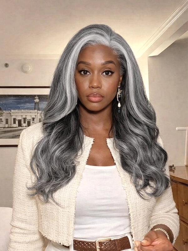 Front view of a long silver grey salt and pepper wavy wig with signature white front streaks, worn by a real model, made of 100% human hair, perfect for natural and elegant everyday styling