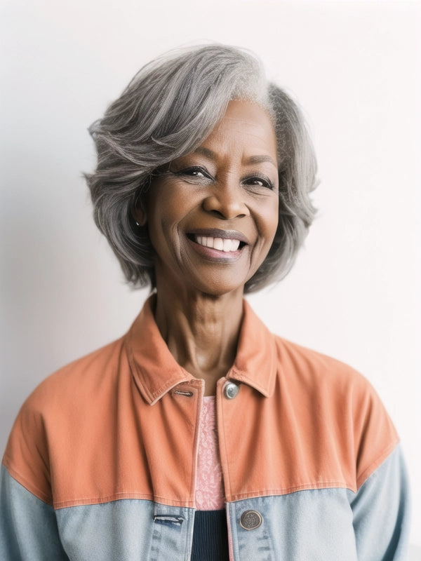 African American woman in Luvwin Silver Gray Custom Layered Cut Side Part Hair, soft layered waves, realistic Salt & Pepper highlights, beginner-friendly human hair wig for women of all ages, suitable for professional events, family gatherings, or weekend activities
