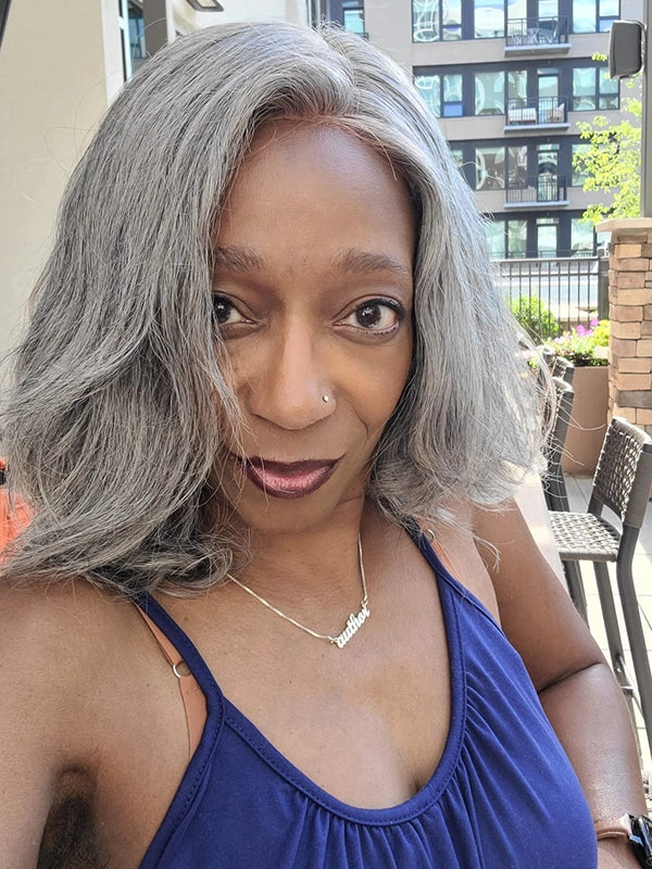 Black woman showcasing Luvwin Gray Layered Wig with Salt & Pepper color, soft natural layers, glueless 5x5 closure lace front, realistic gray highlights, easy-to-style human hair wig for everyday and casual occasions