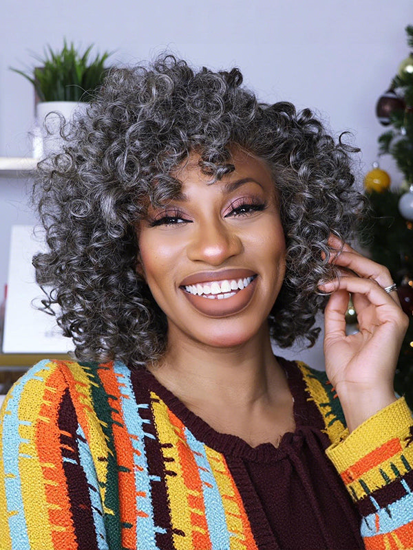Smiling black woman wearing Salt & Pepper bouncy curls glueless 100% human hair grey wig, soft natural curly texture, realistic short gray hairstyle for confident and stylish women.
