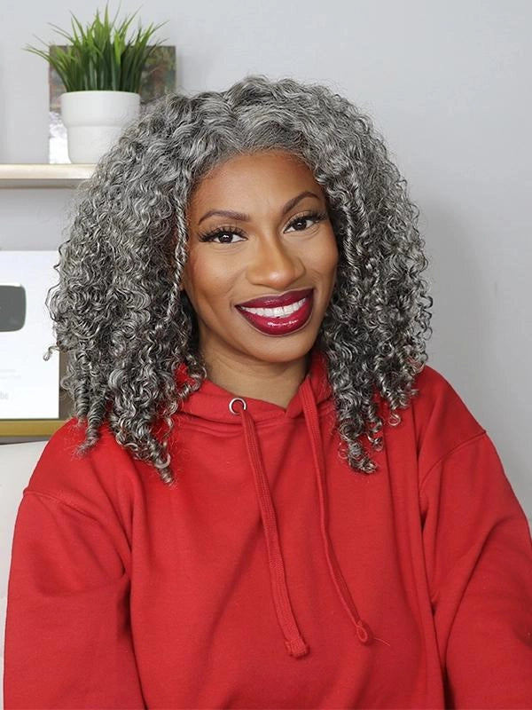 Black woman wearing salt and pepper curly gray bob wig with natural afro curls, soft realistic synthetic hair, short gray hairstyle for mature and stylish women.