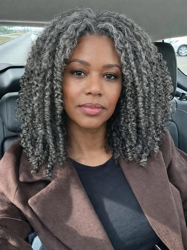 Model wearing salt and pepper natural curly glueless gray bob wig made with human hair, short curly gray wig with soft natural curls and realistic volume.